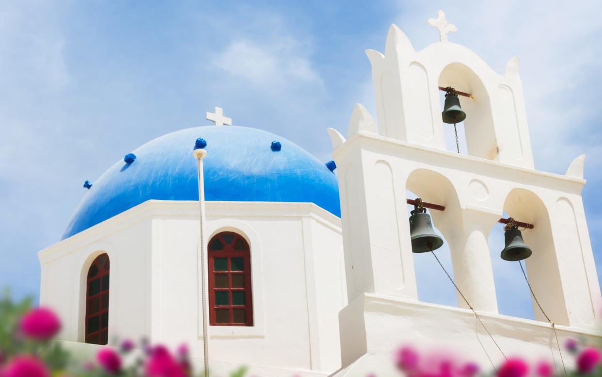 The blue-domed churches that feature on every Greek postcard were painted in the colours of the Greek flag as a symbol of resistance - Getty