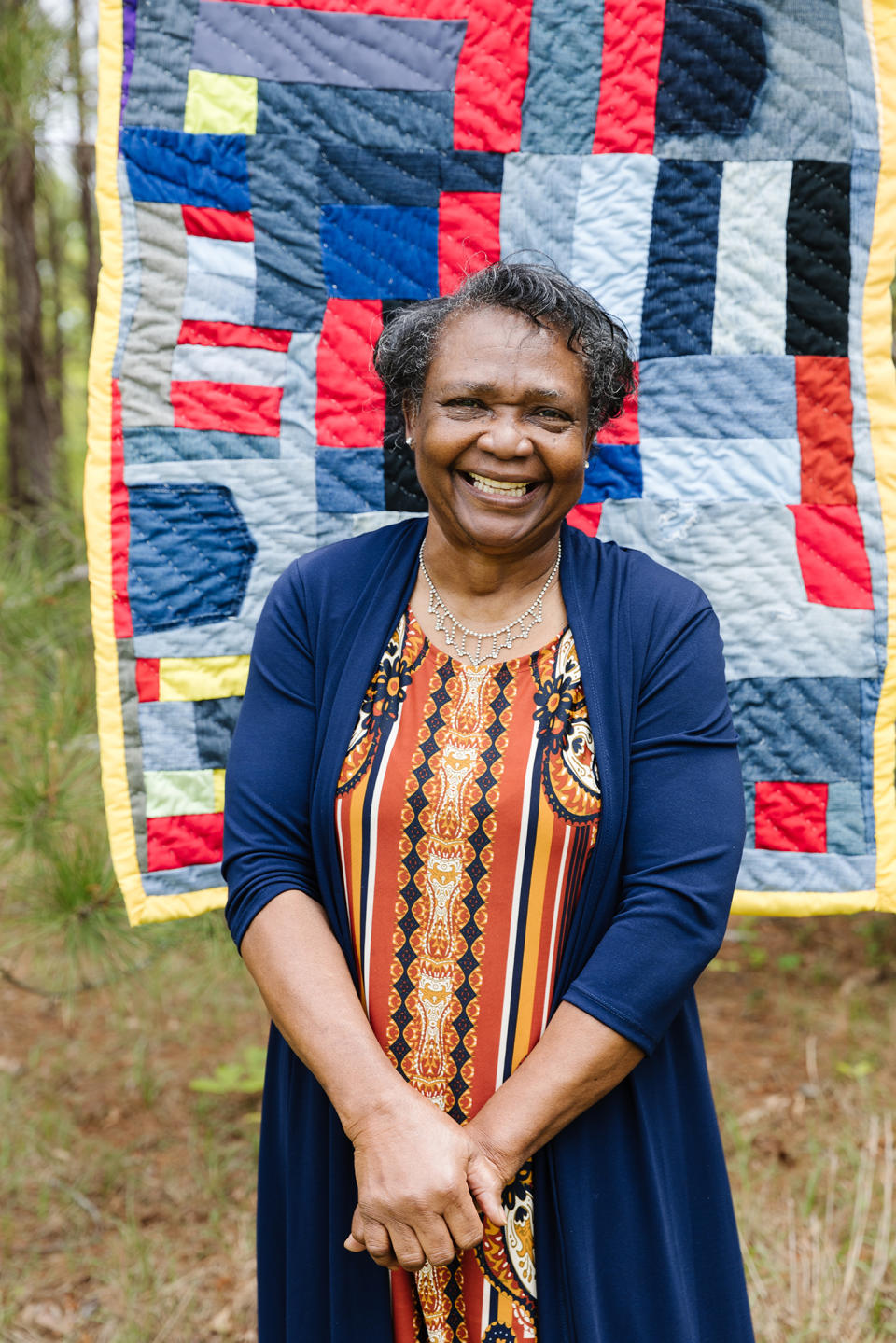 Gee’s Bend quilter Stella Mae Pettway stands in front of one of her quilts. - Credit: Stacy K. Allen