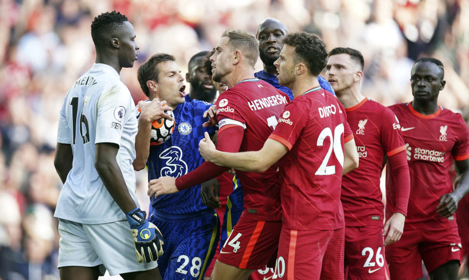 Chelsea's Cesar Azpilicueta, second left, and Liverpool's Jordan Henderson, third left, clash following Liverpool's equaliser during the English Premier League soccer match between Liverpool and Chelsea at Anfield, Liverpool, England, Saturday, Aug. 28, 2021. (Mike Egerton/PA via AP)