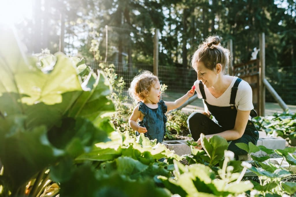 A mother and daughter spend time in their garden. 