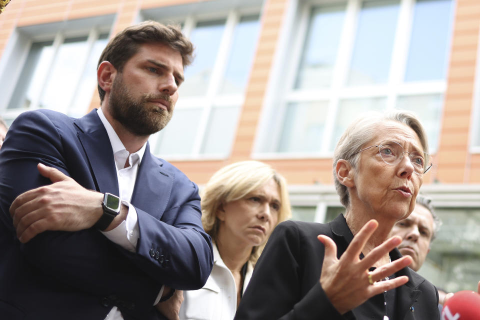 Vincent Jeanbrun, left, the Mayor of L'Hay-les-Roses, and French Prime Minister Elisabeth Borne talks to the medias after rioters rammed a vehicle into his house overnight, at the City Hall in L'Hay-les-Roses, south of Paris, Sunday, July 2, 2023. Young rioters clashed with police and targeted the mayor's home with a burning car as France saw a fifth night of unrest sparked by the police killing of a teenager. (Charly Triballeau/Pool via AP)