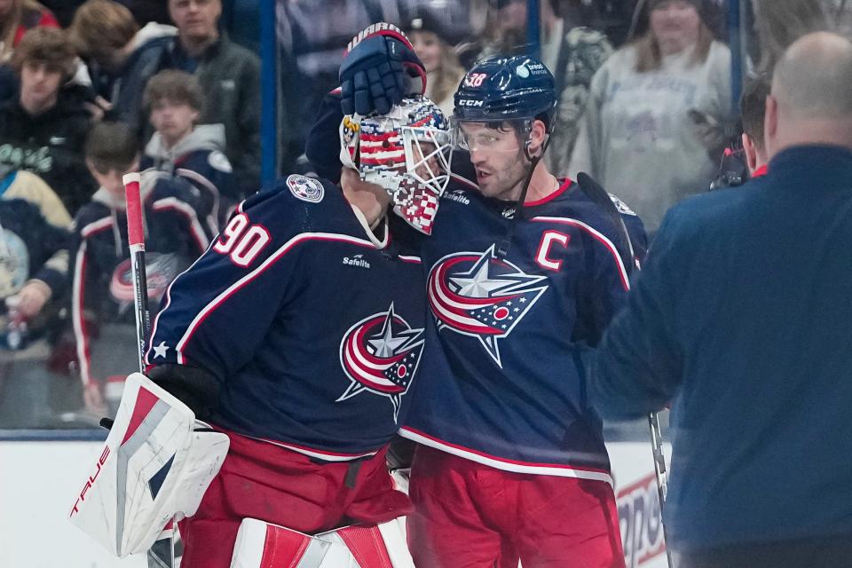 Nov 1, 2023; Columbus, Ohio, USA; Columbus Blue Jackets goaltender Elvis Merzlikins (90) and center Boone Jenner (38) celebrate their 4-2 win over the Tampa Bay Lightning in the NHL hockey game at Nationwide Arena.