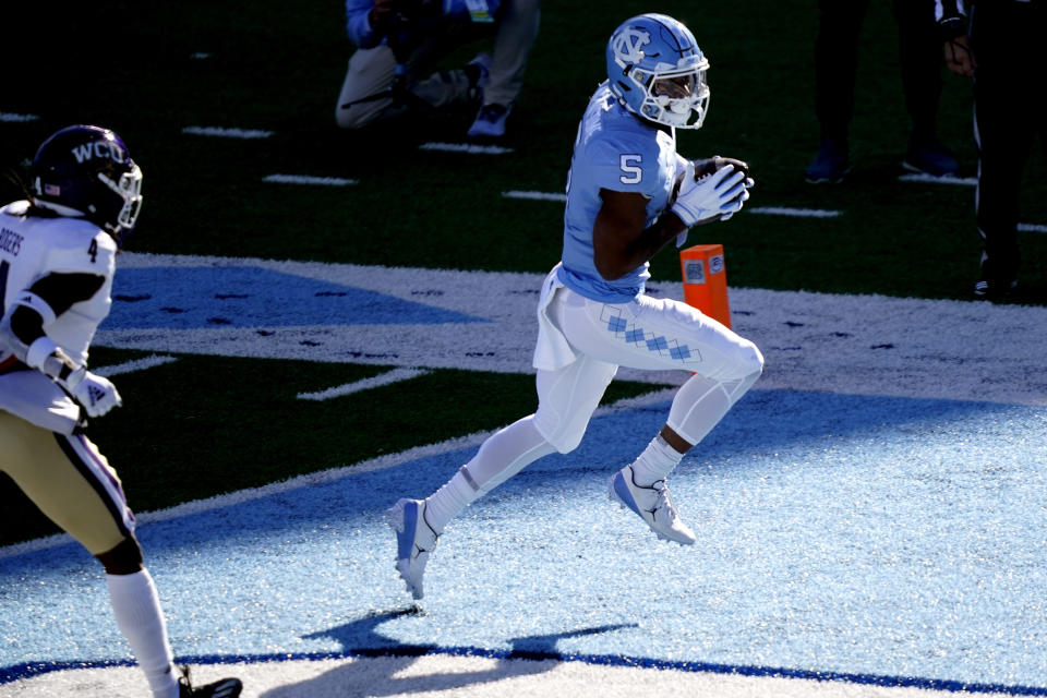 North Carolina wide receiver Dazz Newsome (5) scores a touchdown against Western Carolina during the first half of an NCAA college football game in Chapel Hill, N.C., Saturday, Dec. 5, 2020. (AP Photo/Gerry Broome)