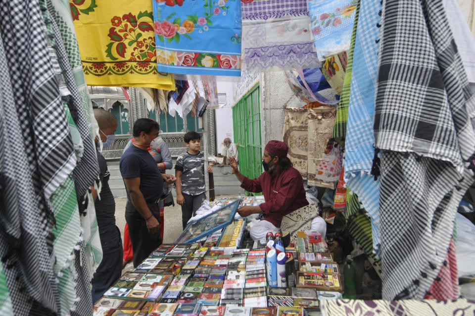 NOIDA, INDIA - JULY 31: People out shopping in the market on the eve of Eid al-Adha at Sector 8 market, on July 31, 2020 in Noida, India. The holy festival of sacrifice, which falls on the 10th day of Dhu al-Hijjah as per the Islamic lunar calendar, is being celebrated today. Bakra Eid or Bakrid is marked by sacrificing an animal that is close to them to prove their devotion and love for Allah. Post the sacrifice, devotees distribute the offering to family, friends, neighbours and especially to the poor and the needy. (Photo by Sunil Ghosh/Hindustan Times via Getty Images)