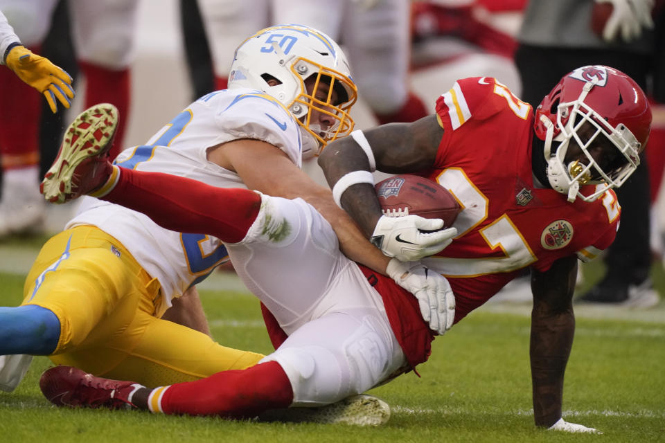 Kansas City Chiefs' Rashad Fenton is tackled by Los Angeles Chargers linebacker Cole Christiansen, left, during the first half of an NFL football game, Sunday, Jan. 3, 2021, in Kansas City. (AP Photo/Charlie Riedel)