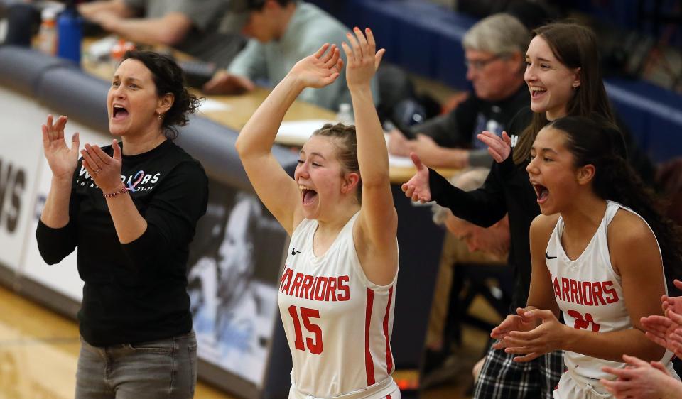 Crosspoint head coach Jenny Kuske and players Kaylee Ajanovic (15) and Riya Tobosa (21) come off the bench to celebrate their 53-29 win over Almira Coulee Hartline at Tacoma Community College on Saturday, Feb. 24, 2024.