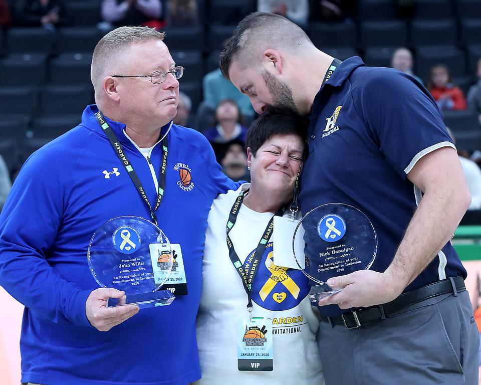 Hanover head coach Nick Hannigan kisses the head of Regina Lawson, Andrew Lawson’s mother, while Norwell head coach John Willis is overcome with emotion after being presented with the Andrew J. Lawson Inclusion Award at halftime of their game at the TD Garden on Saturday, Jan. 25, 2020. Nick Hannigan was an assistant coach at Norwell High from 2005 to 2012 while Andrew was a student there from 2004-2008.