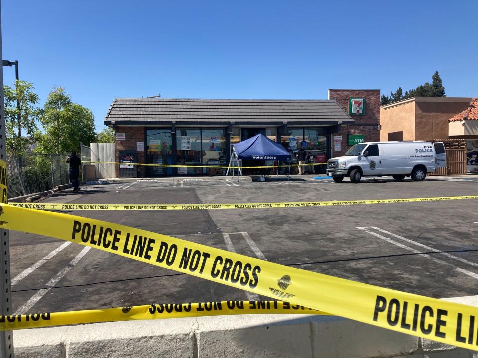 Police crime scene tape closes off a parking area following a shooting at a 7-Eleven store in Brea, Calif., on Monday, July 11, 2022. Police say two people have been killed and three have been wounded in pre-dawn shootings at four Southern California 7-Eleven stores. Authorities said Monday that at least three of the four shootings are believed to be linked to the same lone gunman. (AP Photo/Eugene Garcia)