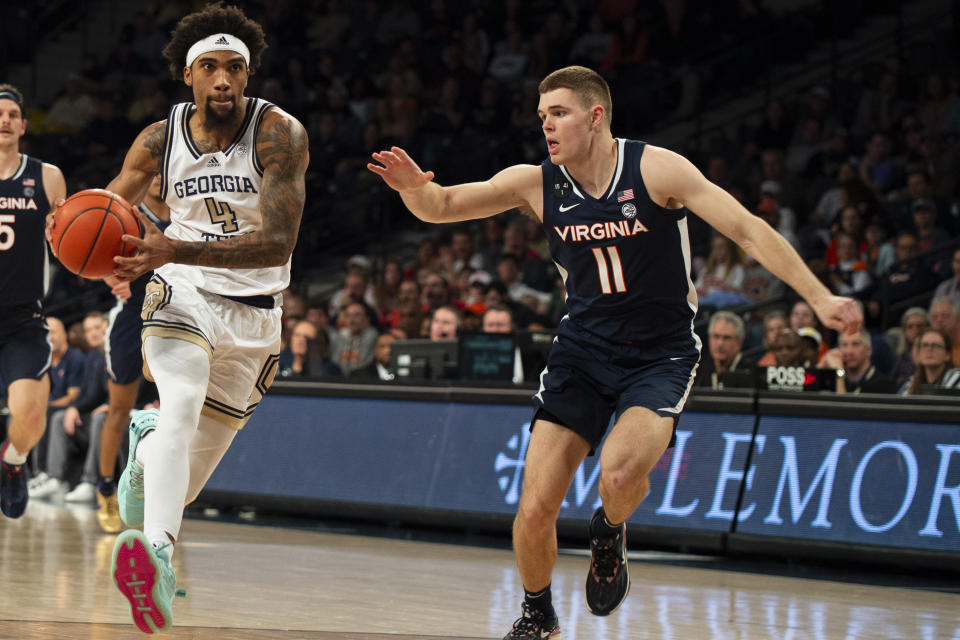 Georgia Tech forward Javon Franklin drives past Virginia guard Isaac McKneely in the second half of an NCAA college basketball game, Saturday, Dec. 31, 2022, in Atlanta. (AP Photo/Hakim Wright Sr.)