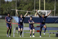 U.S. men's national team soccer players, including Paxton Pomykal, second from left, and Paul Arriola, second from right, team run through drills during training, Wednesday, Jan. 8, 2020, in Bradenton, Fla. The team moved its training camp from Qatar to Florida in the wake of Iran's top military commander being killed during a U.S. airstrike in the Middle East. (AP Photo/Chris O'Meara)