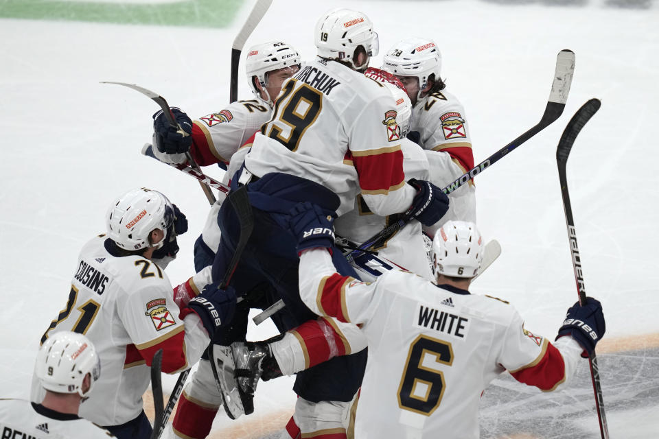 Florida Panthers left wing Matthew Tkachuk (19) leaps on goaltender Sergei Bobrovsky (72) while celebrating after scoring the game-winning goal against the Boston Bruins during overtime of Game 5 in the first round of the NHL hockey playoffs, Wednesday, April 26, 2023, in Boston. (AP Photo/Charles Krupa)