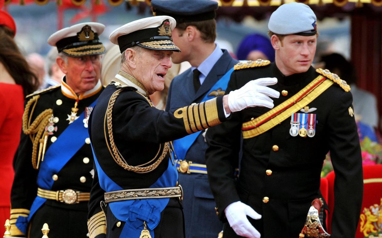 Prince Charles, Prince of Wales, Prince Philip, Duke of Edinburgh, Prince William and Prince Harry talk onboard the Spirit of Chartwell during the Thames Diamond Jubilee Pageant on the River Thames in London - AFP