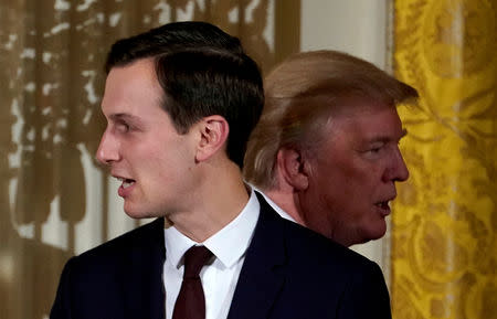 FILE PHOTO: FILE PHOTO: U.S. President Donald Trump passes his adviser and son-in-law Jared Kushner during a Hanukkah Reception at the White House in Washington, U.S., December 7, 2017. REUTERS/Kevin Lamarque/File Photo/File Photo