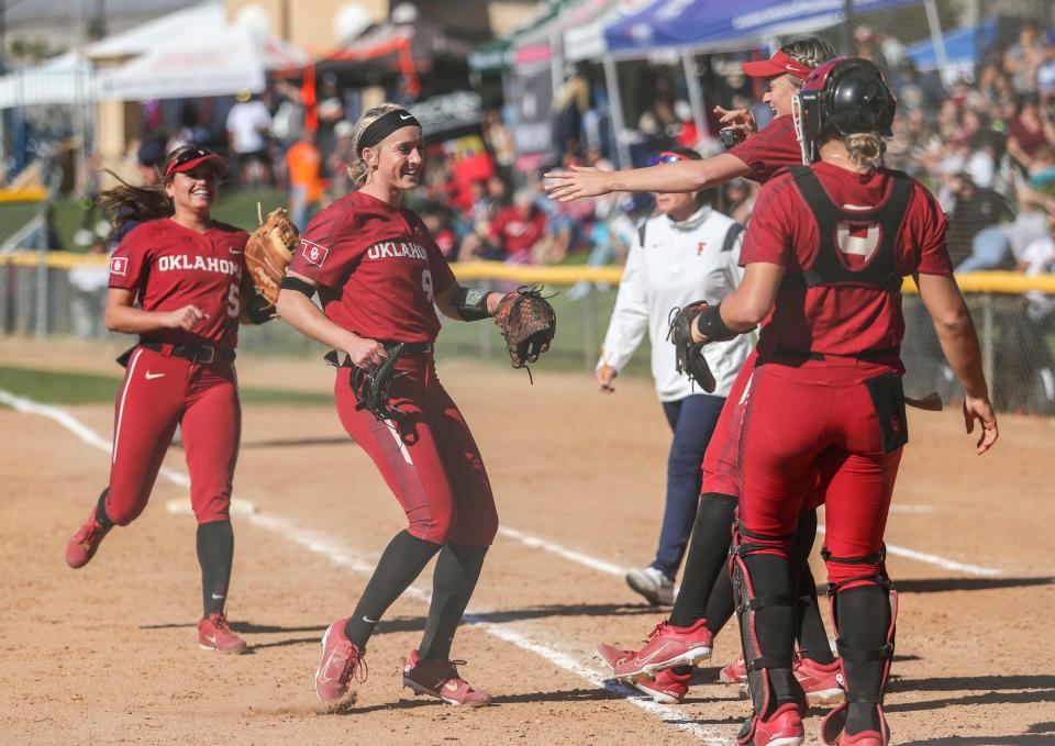 Oklahoma's Jordyn Bahl (98) celebrates pitching a perfect game to a 10-0 win over CSU Fullerton during the Mary Nutter Collegiate Classic in Cathedral City, Calif., Friday, Feb. 25, 2022.