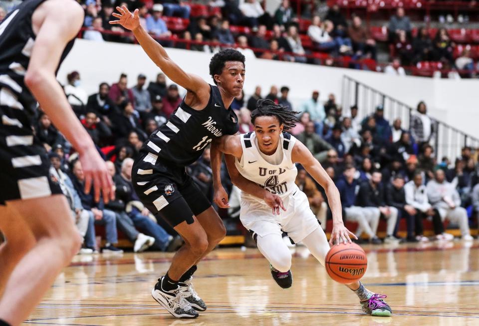 U-D Jesuit's Ryan Hatcher (4) dribbles against Birmingham Brother Rice guard Warren Marshall (13) during the first half of the Bishop division of CHSL championship game at Calihan Hall in Detroit on Friday, Feb. 24, 2023.