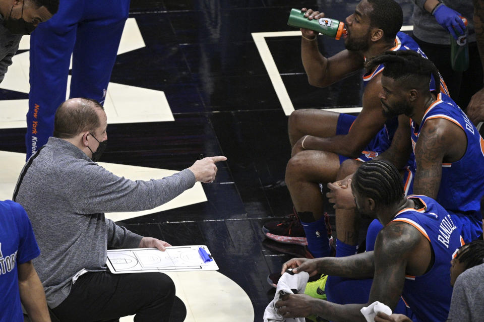 New York Knicks coach Tom Thibodeau, left, gives instructions during a timeout in the second half of the team's NBA basketball game against the Orlando Magic, Wednesday, Feb. 17, 2021, in Orlando, Fla. (AP Photo/Phelan M. Ebenhack)