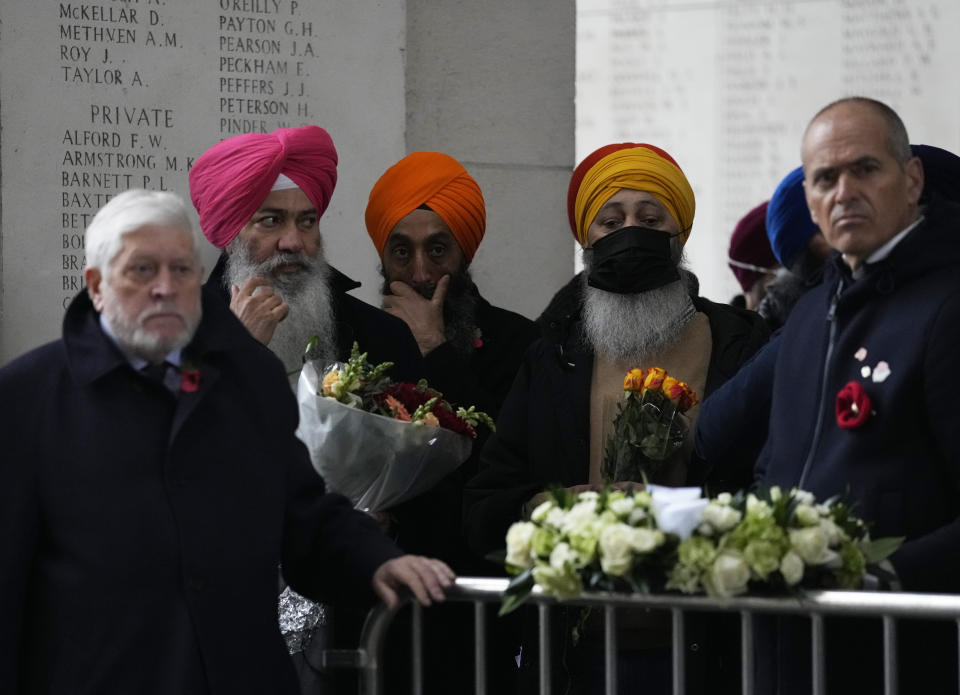 Members of delegations and the general public wait as they prepare to lay wreaths during an Armistice Day ceremony at the Menin Gate Memorial to the Missing in Ypres, Belgium, Thursday, Nov. 11, 2021. (AP Photo/Virginia Mayo)
