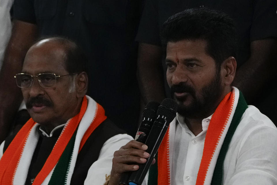 Telangana Pradesh Congress Committe president Anumula Revanth Reddy, right along with Manik Rao Thakre addresses a press conference after leads for their party in Telangana state elections in Hyderabad, India, Sunday, Dec.3, 2023. India’s Hindu nationalist party was headed for a clear win in three out of four states Sunday, according to the election commission’s website. (AP Photo/Mahesh Kumar A)