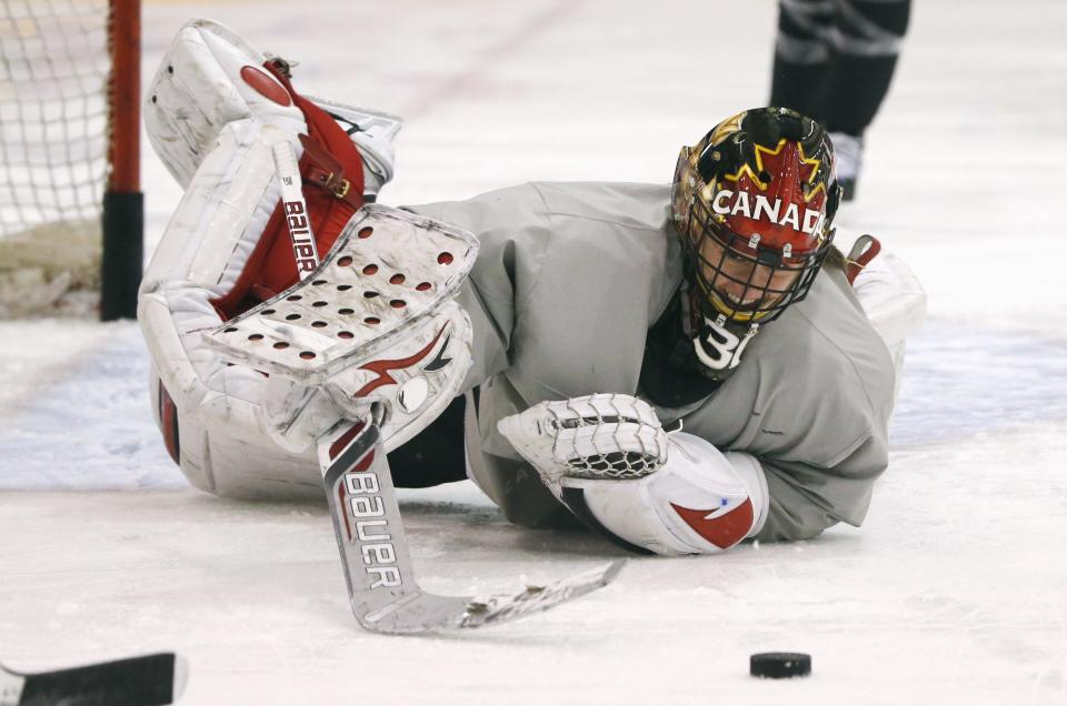 Canada's goalie Genevieve LaCasse makes a save during a women's ice hockey team practice at the 2014 Sochi Winter Olympics February 19, 2014. REUTERS/Lucy Nicholson (RUSSIA - Tags: SPORT OLYMPICS ICE HOCKEY)