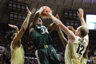 Michigan State forward Julius Marble (34) is defended by Purdue forward Evan Boudreaux (12) and Purdue guard Nojel Eastern (20) as he shoots during the first half of an NCAA college basketball game in West Lafayette, Ind., Sunday, Jan. 12, 2020. (AP Photo/Michael Conroy)