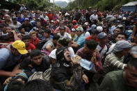 Hundreds of Hondurans are blocked at the border crossing in Agua Caliente, Guatemala, Monday, Oct. 15, 2018. A caravan of Honduran migrant moved towards the country's border with Guatemala in a desperate attempt to flee poverty and seek new lives in the United States. (AP Photo/Moises Castillo)