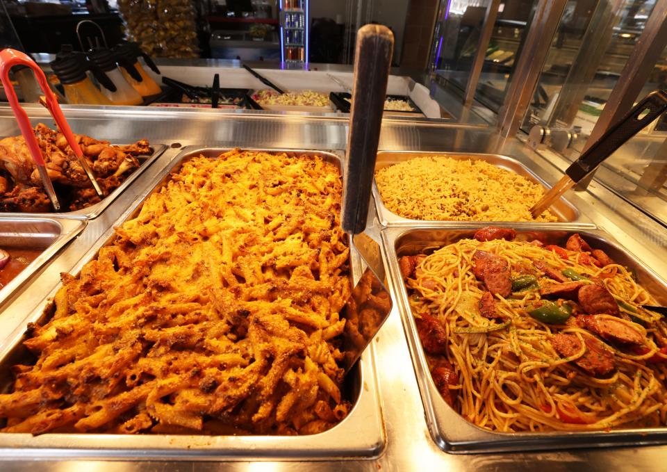 Chef Mirbentz Jean Francois uses his recipes to create a daily spread of Haitian food at America's Food Basket in Randolph.