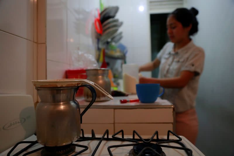 Jetsymar Torres from Venezuela prepares coffee at her house in Bogota