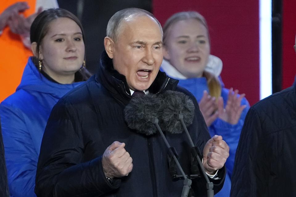 Russian President Vladimir Putin gestures while addressing a crowd at a concert marking his victory in a presidential election and the 10-year anniversary of Crimea's annexation by Russia on Red Square in Moscow, Russia, Monday, March 18, 2024. President Vladimir Putin seized Crimea from Ukraine a decade ago, a move that sent his popularity soaring but was widely denounced as illegal. (AP Photo/Alexander Zemlianichenko)