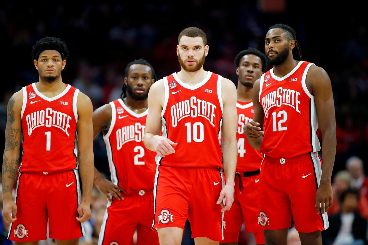 Dec 21, 2023; Columbus, Ohio, USA; Ohio State Buckeyes forward Jamison Battle (10) and guard Evan Mahaffey (12) and guard Roddy Gayle Jr. (1) and guard Bruce Thornton (2) and guard Dale Bonner (4) watch as a technical is called during the first half against the New Orleans Privateers at Value City Arena. Mandatory Credit: Joseph Maiorana-USA TODAY Sports