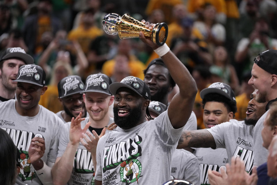 Boston Celtics guard Jaylen Brown, center, celebrates with his teammates after Game 4 of the NBA Eastern Conference basketball finals against the Indiana Pacers, Monday, May 27, 2024, in Indianapolis. The Celtics won 105-102. (AP Photo/Michael Conroy)