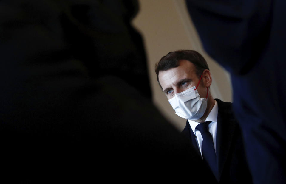 French President Emmanuel Macron listening to cadets prior to his New Year's speech to the French Armed Forces at Brest naval training center, western France, Tuesday, Jan. 19, 2021. (Stephane Mahe/Pool Photo via AP)