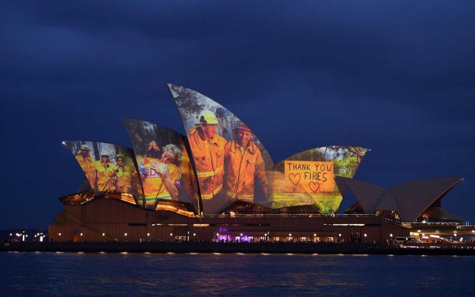 The sails of the Opera House are lit with a series of images to show support for the communities affected by the bushfires and to express the gratitude to the emergency services and volunteers in Sydney on January 11, 2020 | SAEED KHAN/Getty Images