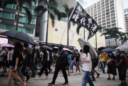 Anti-government demonstrators march in protest against the invocation of the emergency laws in Hong Kong