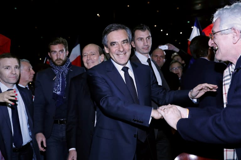 Militants greet French presidential election candidate for the right-wing Les Republicains (LR) party Francois Fillon (C) as he arrives for a public rally in Maisons-Alfort, near Paris, on February 24, 2017