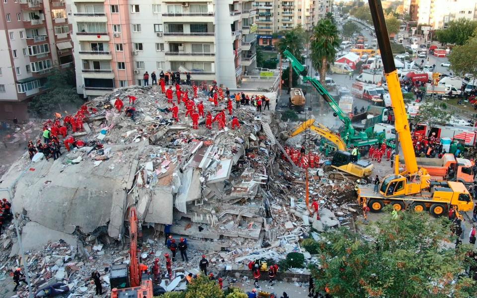 Rescue services search for survivors in the debris of collapsed buildings in Izmir, Turkey - IHA