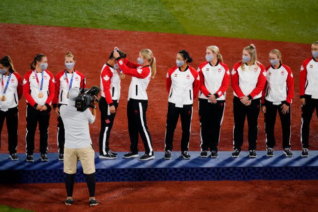 Members of Team Canada receive their bronze medals on the podium during the medal ceremony for softball on July 27 in Yokohama. (Photo: Matt Slocum via AP)