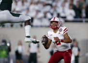 Nebraska quarterback Adrian Martinez, right, looks to throw as Michigan State's Michael Dowell, left, defends during the second quarter of an NCAA college football game, Saturday, Sept. 25, 2021, in East Lansing, Mich. (AP Photo/Al Goldis)