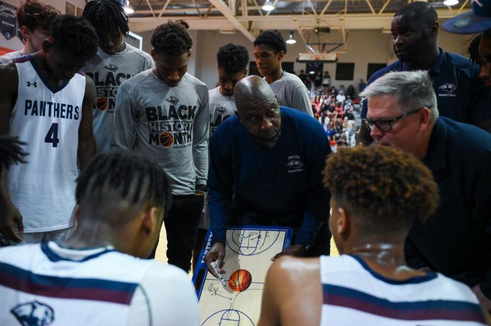 Dwyer head coach Fred Ross draws up a play during a 4th-quarter timeout during the Class 6A District 13 final between host Dwyer and Martin County in Jupiter, FL, on Friday, February 11, 2022. Final score, Martin County, 49, Dwyer, 48.