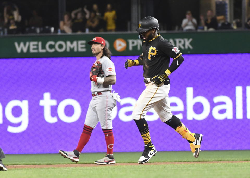 Pittsburgh Pirates' Rodolfo Castro, right, passes Cincinnati Reds second baseman Jonathan India after hitting a solo home run off pitcher Justin Dunn during the fourth inning of a baseball game, Saturday, Aug. 20, 2022, in Pittsburgh. (AP Photo/Philip G. Pavely)