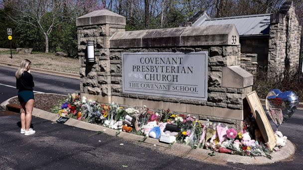 PHOTO: A woman pauses as she visits a memorial at the entrance to The Covenant School, March 29, 2023, in Nashville, Tenn. (Wade Payne/AP, FILE)