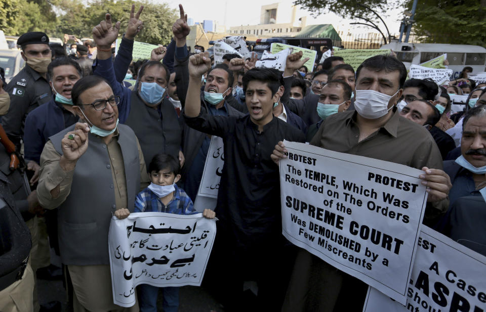 Members of Pakistan Hindu Council hold a protest against the attack on a Hindu temple in the northwestern town of Karak, in Karachi, Pakistan, Thursday, Dec. 31, 2020. Pakistani police arrested 14 people in overnight raids after a Hindu temple was set on fire and demolished by a mob led by supporters of a radical Islamist party, officials said. The temple's destruction Wednesday in the northwestern town of Karak drew condemnation from human rights activists and the minority Hindu community. (AP Photo/Fareed Khan)