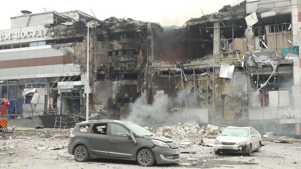 Destroyed cars are seen outside a shopping mall hit in a massive Russian missile and drone strike in Dnipro, Ukraine, on December 29, 2023. - Ukrinform/NurPhoto/Getty Images