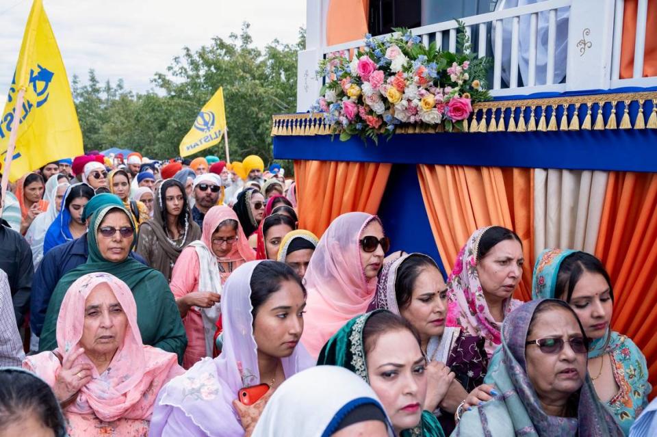 Sikh women march next to the float carrying the holy scripture at the Yuba City Nagar Kirtan parade on Sunday, Nov. 5, 2023.
