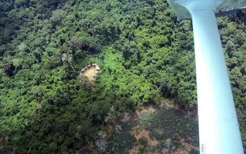 Huts of an remote Yanomami tribe, inside the Yanomami territory in Roraima, northern Brazil, - Credit: AFP