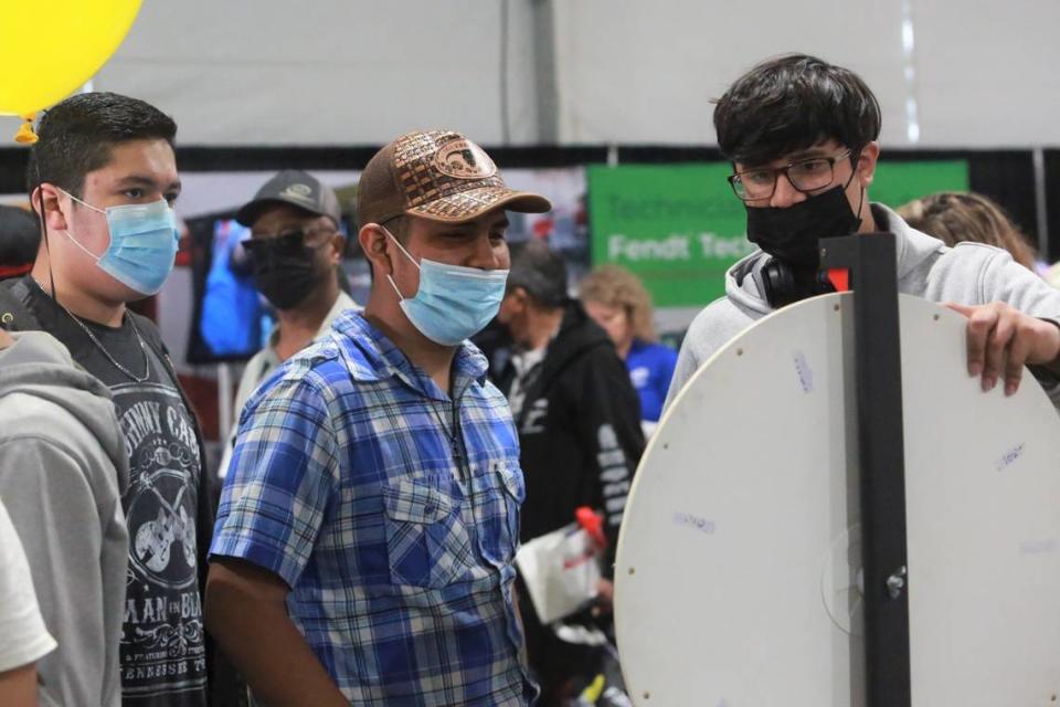 Mendota High School students Jesús Figueroa, Tomas Pérez, and Edgar Larreynaga stopped at the California State Polytechnic University, Pomona booth inside the Ag Career and Education tent at the World Ag Expo on Tuesday, Feb. 8, 2022.