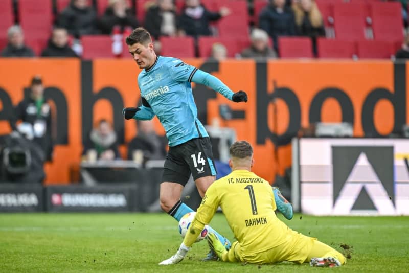 Augsburg goalkeeper Finn Dahmen (R) and Leverkusen's Patrik Schick (L) battle for the ball during the German Bundesliga soccer match between FC Augsburg and Bayer Leverkusen at the WWK Arena. Harry Langer/dpa