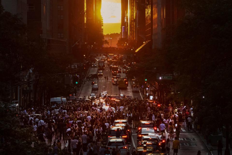 July 11, 2022: The sun sets over Manhattan on 42nd street during "Manhattanhenge" in New York. The Manhattanhenge is an event in which the sunset or sunrise is aligned on the east-west grid of main streets in Manhattan, New York.