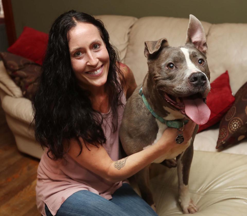 Tisha Angelo, a certified professional dog trainer and owner of Second Chance Canine, with Hank, a pit bull that was available for adoption in 2021.