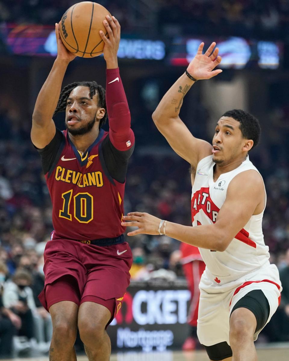 Cleveland Cavaliers' Darius Garland (10) drives against Toronto Raptors' Tremont Waters in the first half of an NBA basketball game, Sunday, Dec. 26, 2021, in Cleveland. (AP Photo/Tony Dejak)