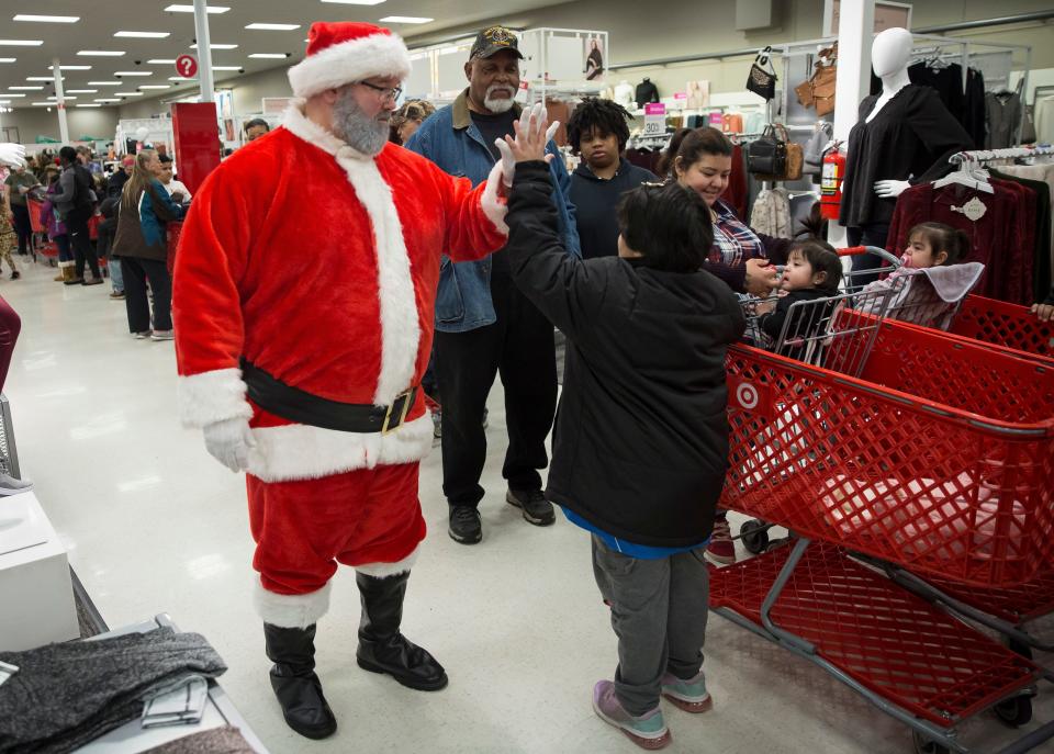 Children and their families are greeted by Santa while waiting in line in December 2019 for the annual Heroes and Helpers event at Target.